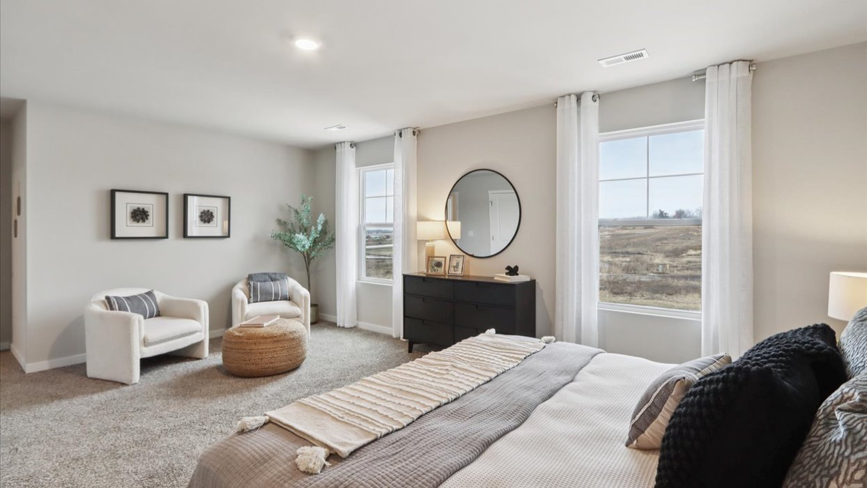 Primary bedroom with natural lighting and spacious layout