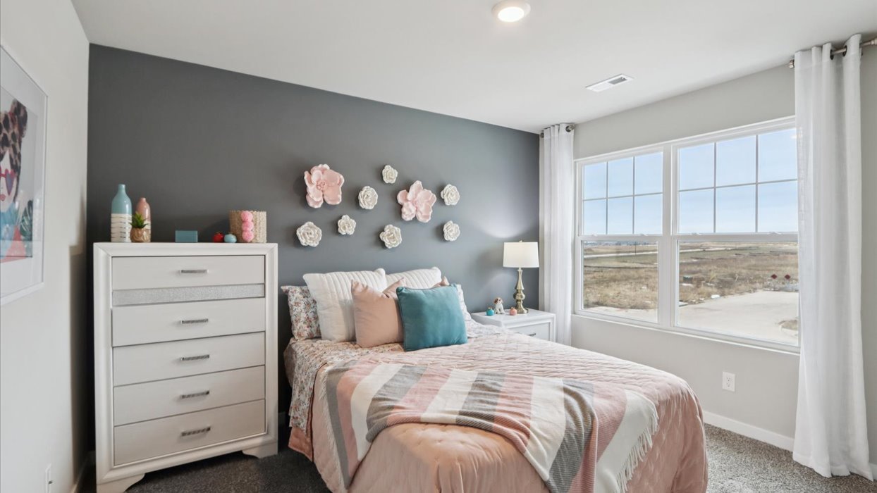 Comfortable secondary bedroom with natural light, modern finishes, and versatile living space.