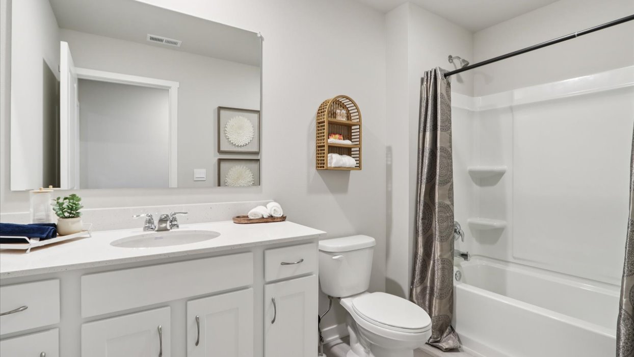 Bathroom with tub and shower combo, quartz countertops, and white vanity