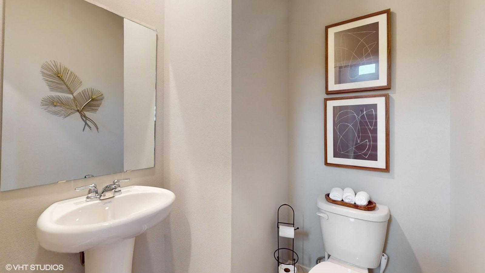 Convenient main-level powder room with updated fixtures and bright lighting.