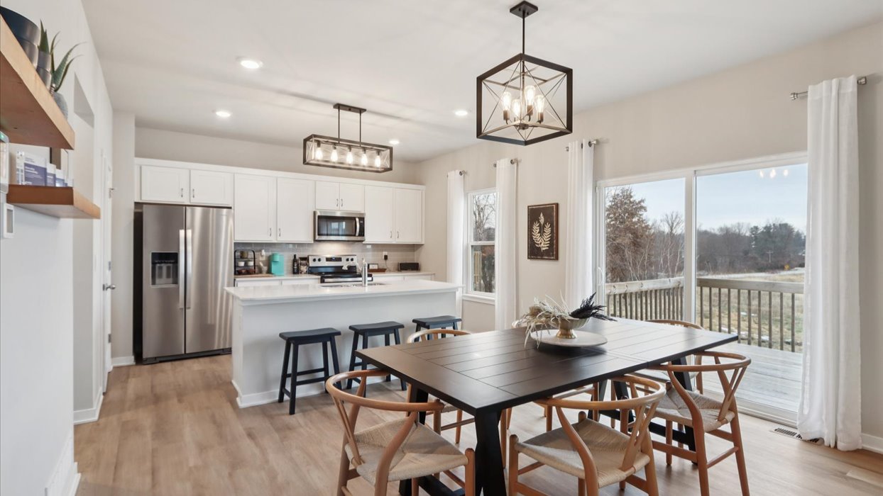 Open concept dining space with access to backyard