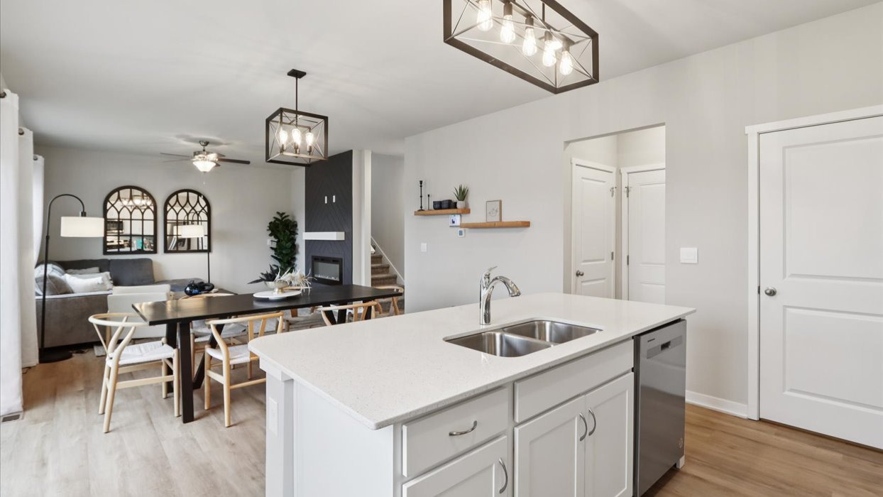Kitchen with stainless steel appliances, quartz countertops, and white cabinetry