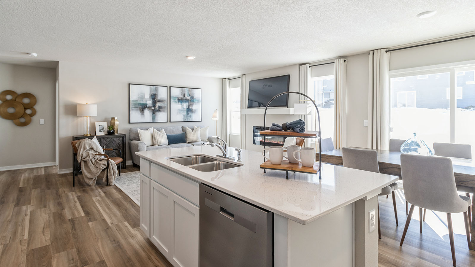 Other side view of kitchen with pantry, cabinets near basement stairs, dining and living areas