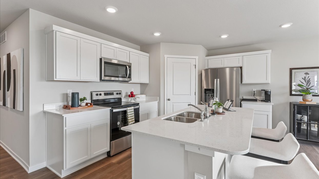 white kitchen with stainless-steel appliances and island