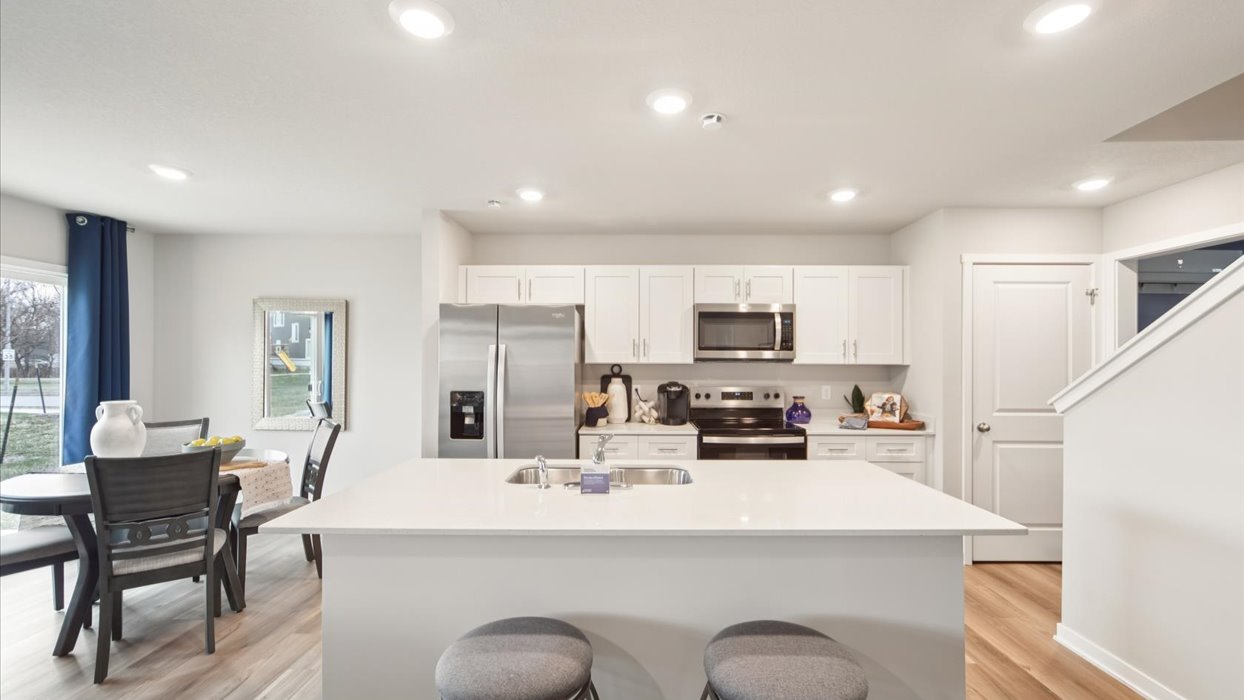 modern kitchen with white cabinets and island with quartz countertops