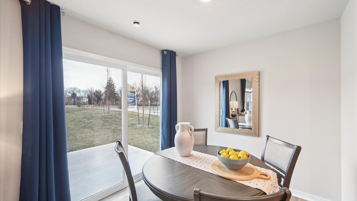 dining area with round wood table next to sliding glass doors