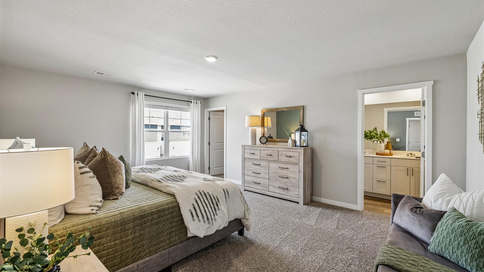 Primary bedroom with natural lighting and spacious layout