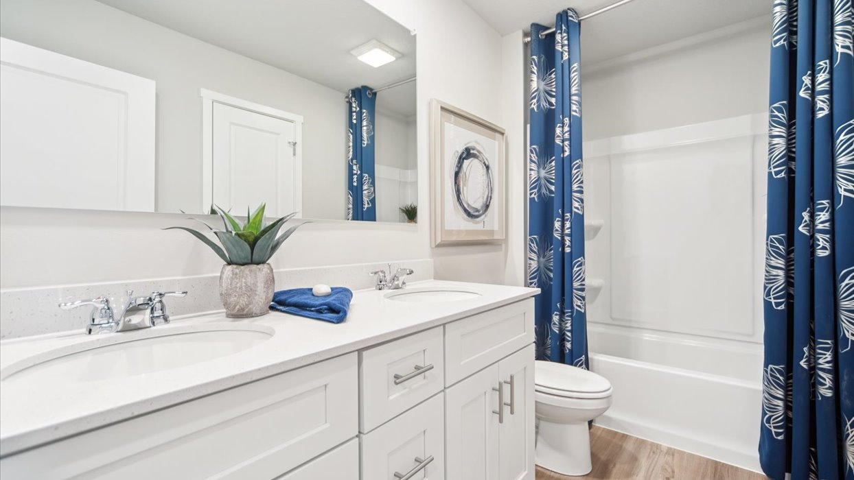 Stylish full bathroom with bright lighting and functional design.