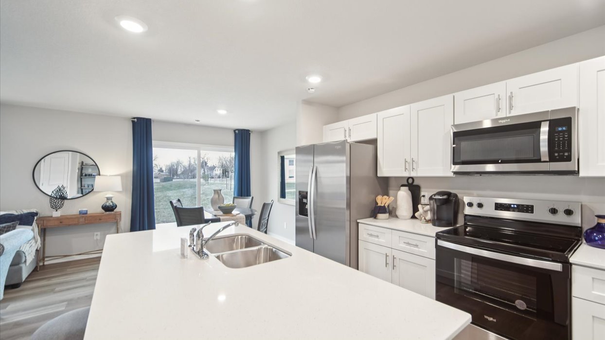 Kitchen with white cabinetry and quartz countertop