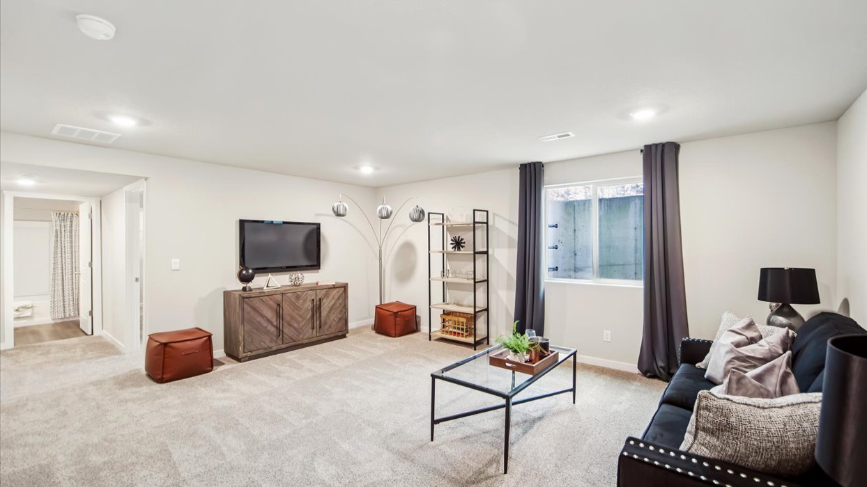 Finished basement living area with comfortable seating space and flexible room for entertaining or relaxing.