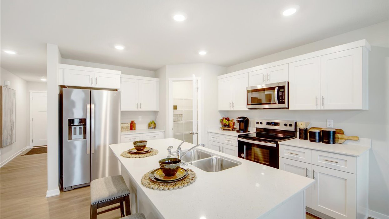 Kitchen with white cabinetry and quartz countertop