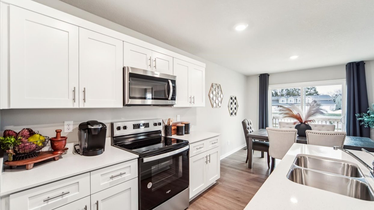 Kitchen with white cabinetry and quartz countertop