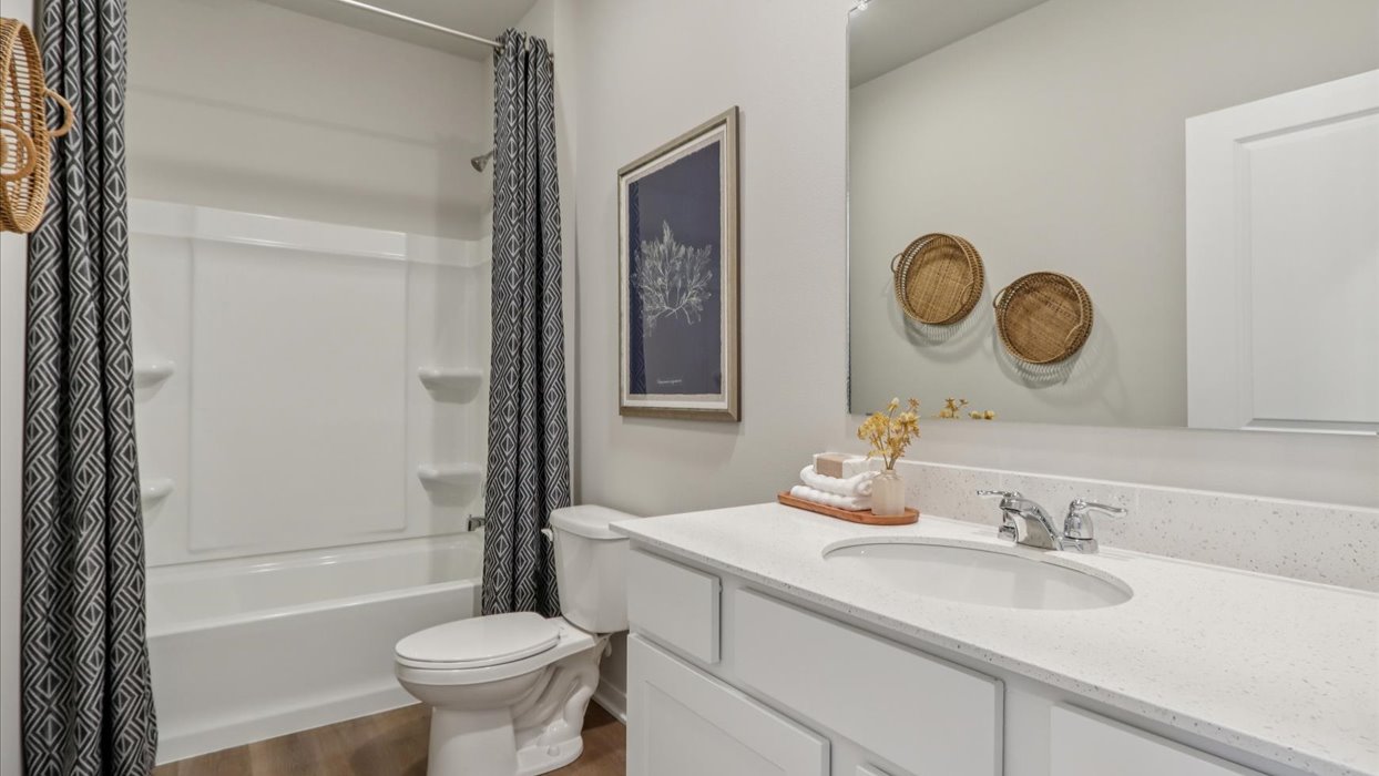Bathroom with tub and shower combo, quartz countertops, and white vanity