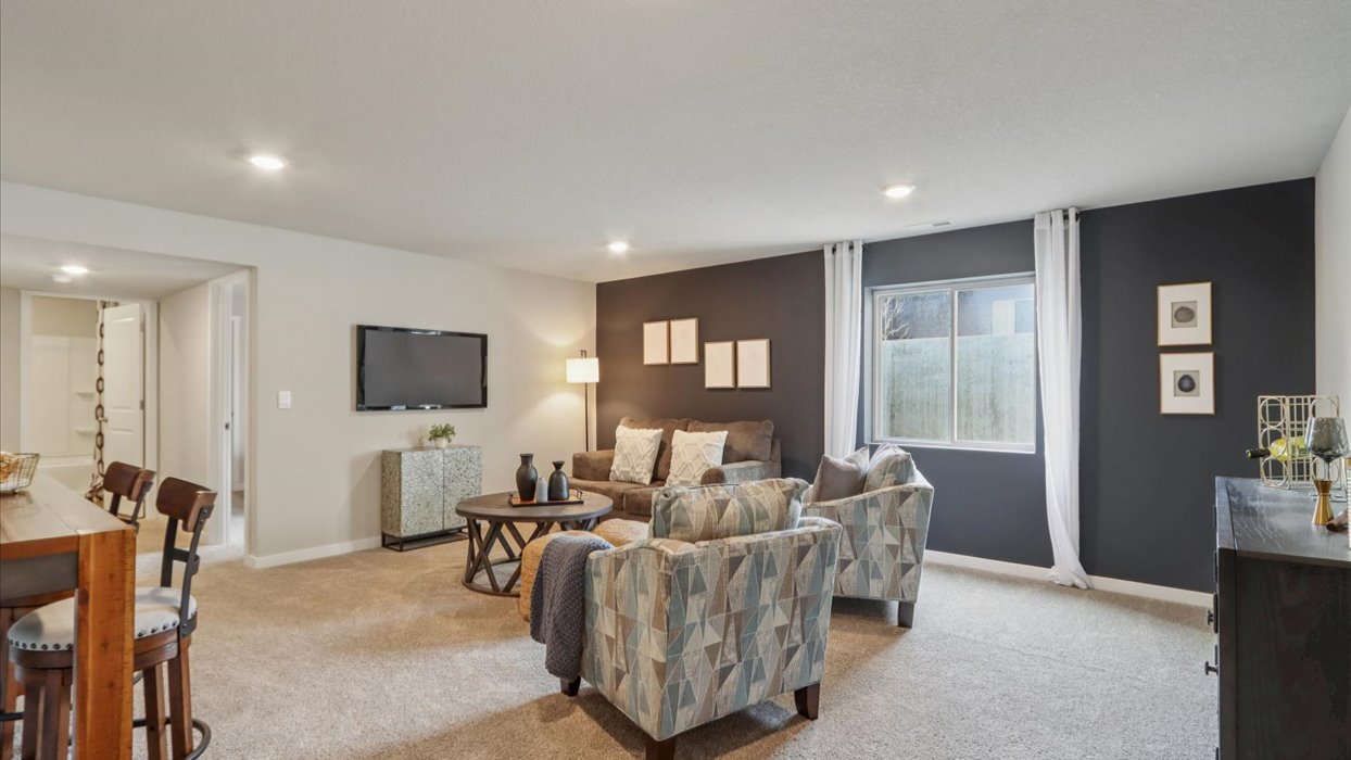 Finished basement living area with comfortable seating space and flexible room for entertaining or relaxing.