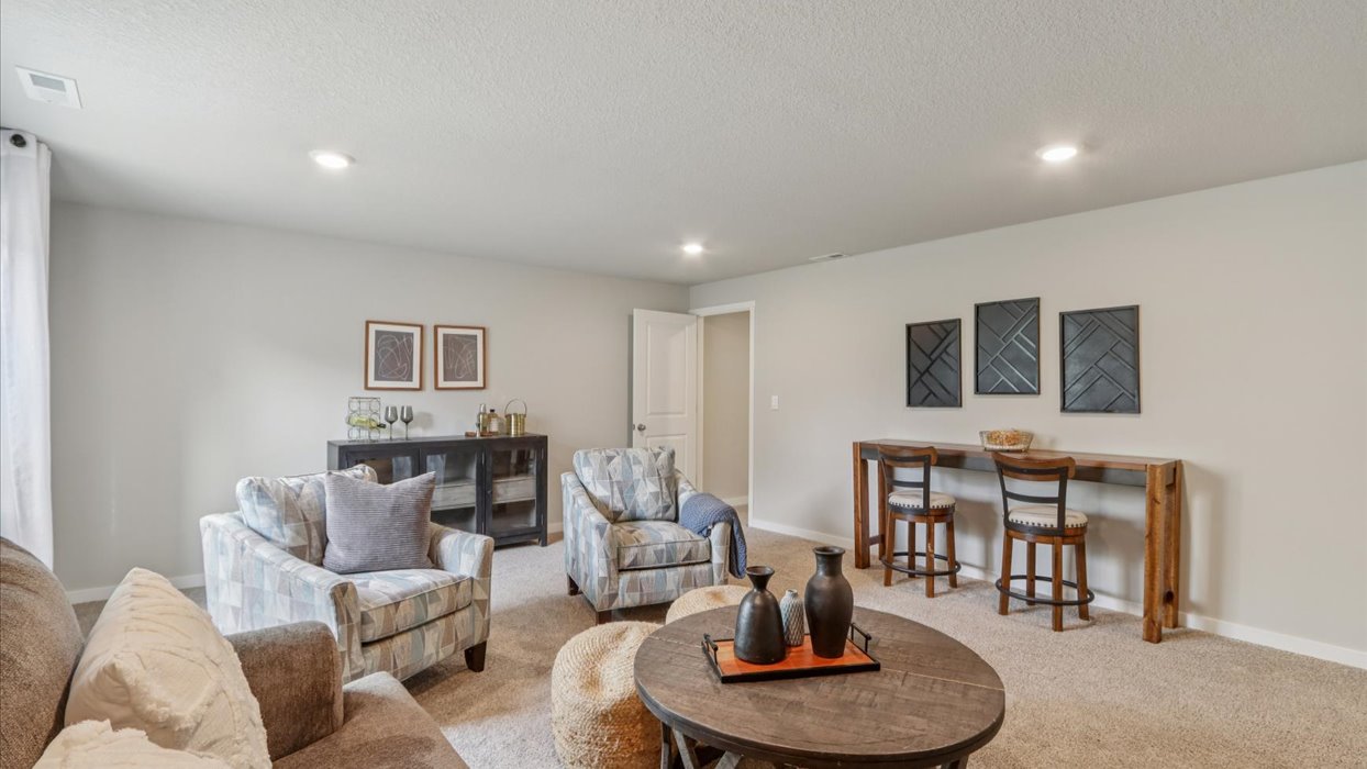 Finished basement living area with comfortable seating space and flexible room for entertaining or relaxing.