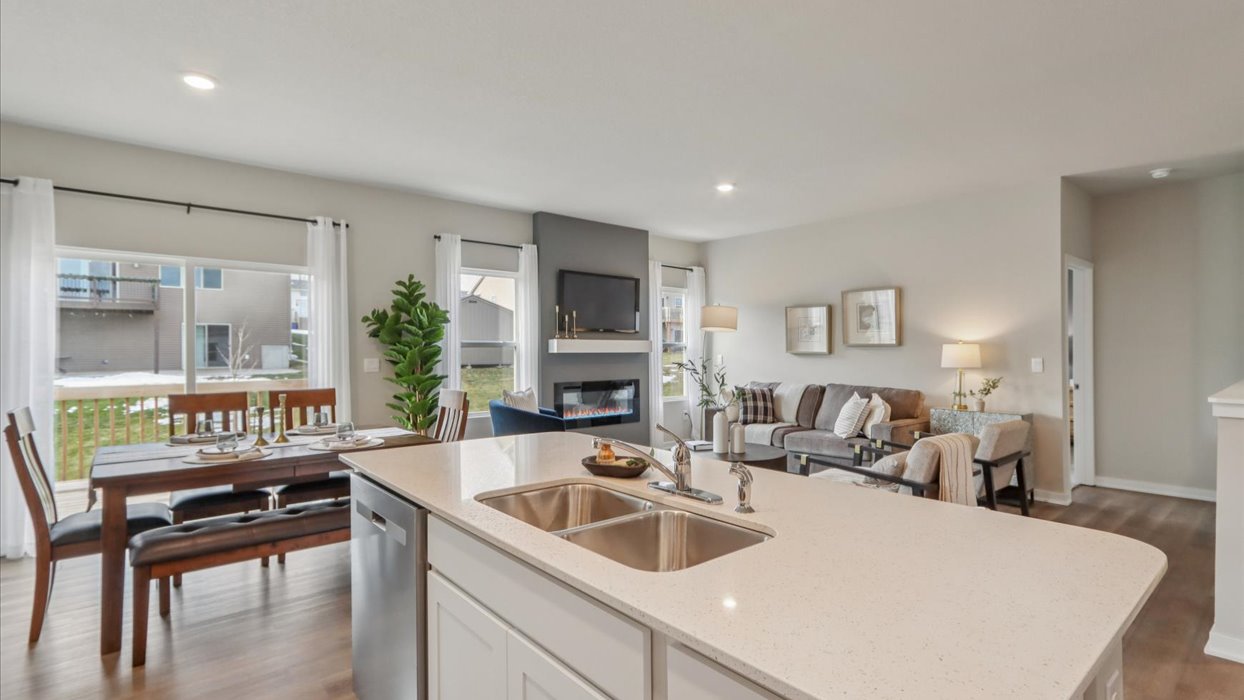 Kitchen with stainless steel appliances, quartz countertops, and white cabinetry