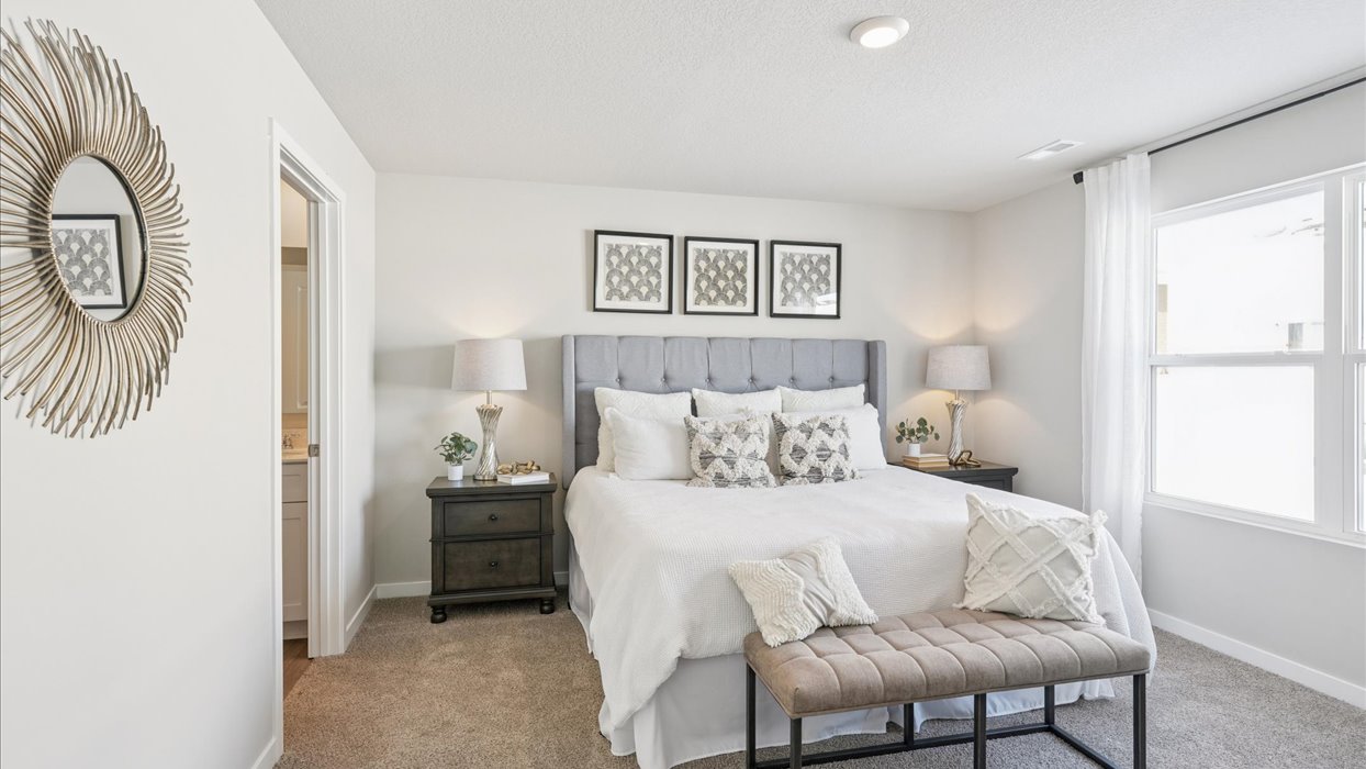 large primary bedroom with window and bathroom attached