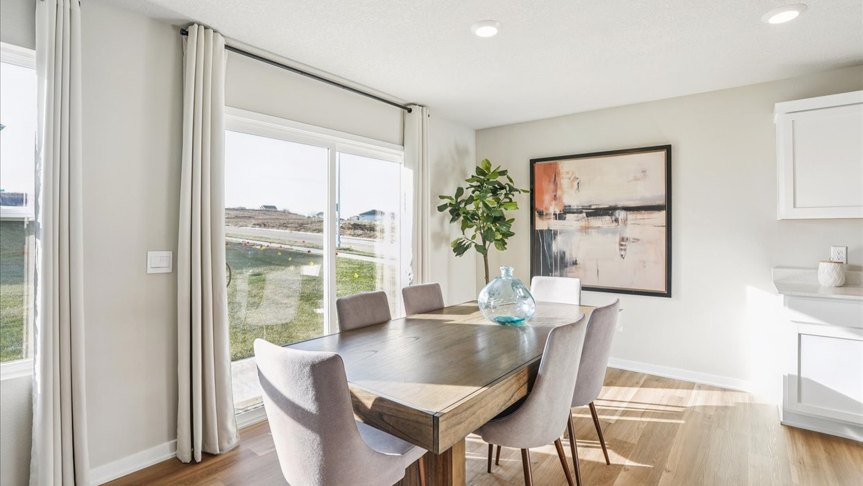 dining area with wood dining table next to sliding glass doors