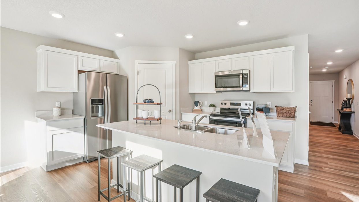 white kitchen with island and quartz countertops