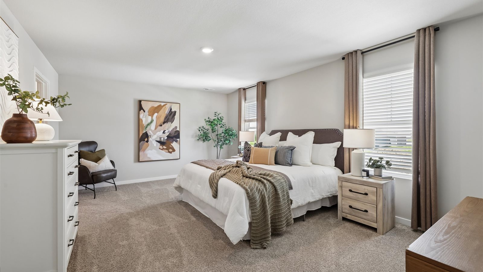 Spacious primary suite with natural light, attached bathroom, & walk in closet