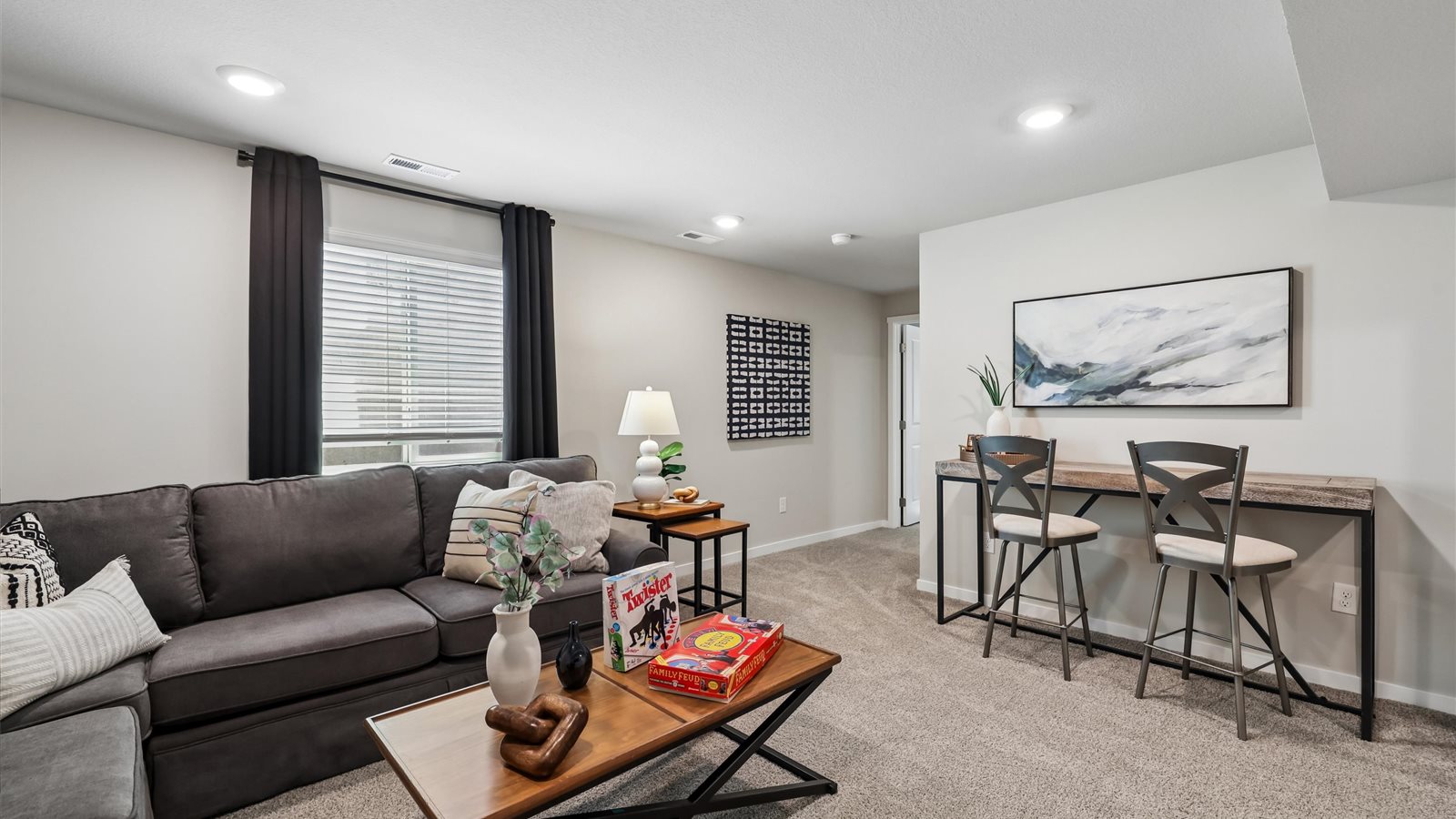 Finished basement living area with comfortable seating space and flexible room for entertaining or relaxing.