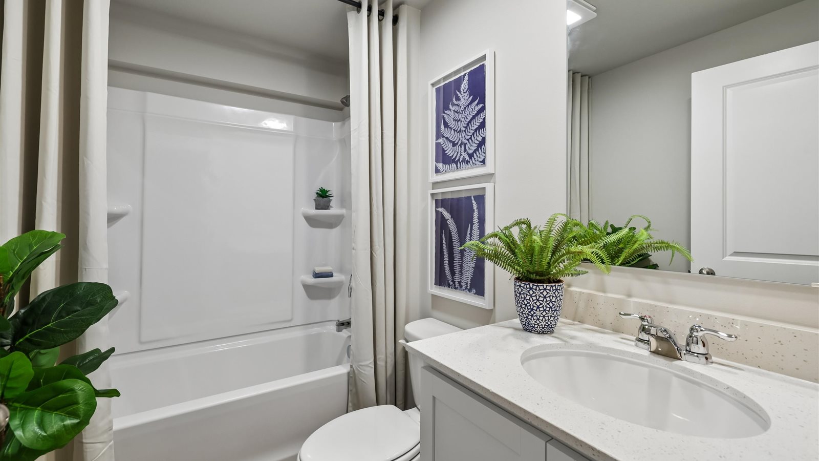 Bathroom with tub and shower combo, quartz countertops, and white vanity