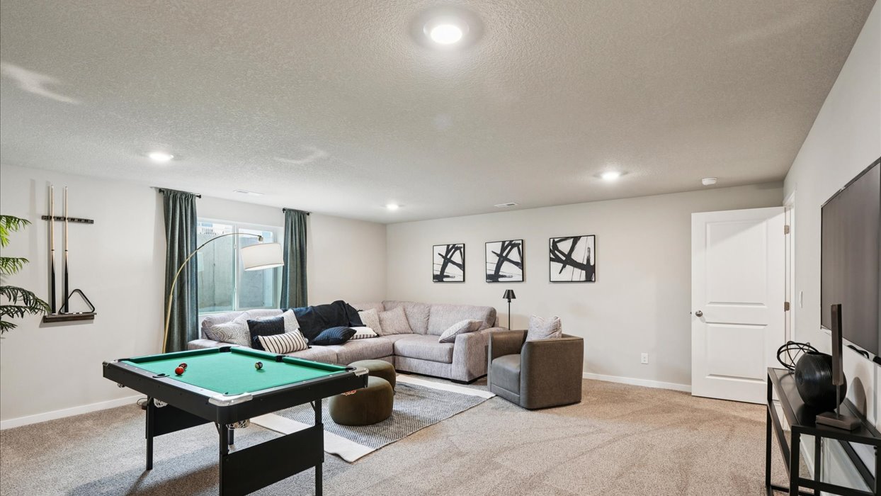 Finished basement living area with comfortable seating space and flexible room for entertaining or relaxing.