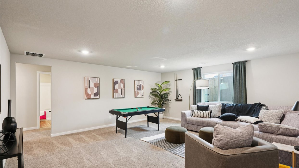 Finished basement living area with comfortable seating space and flexible room for entertaining or relaxing.