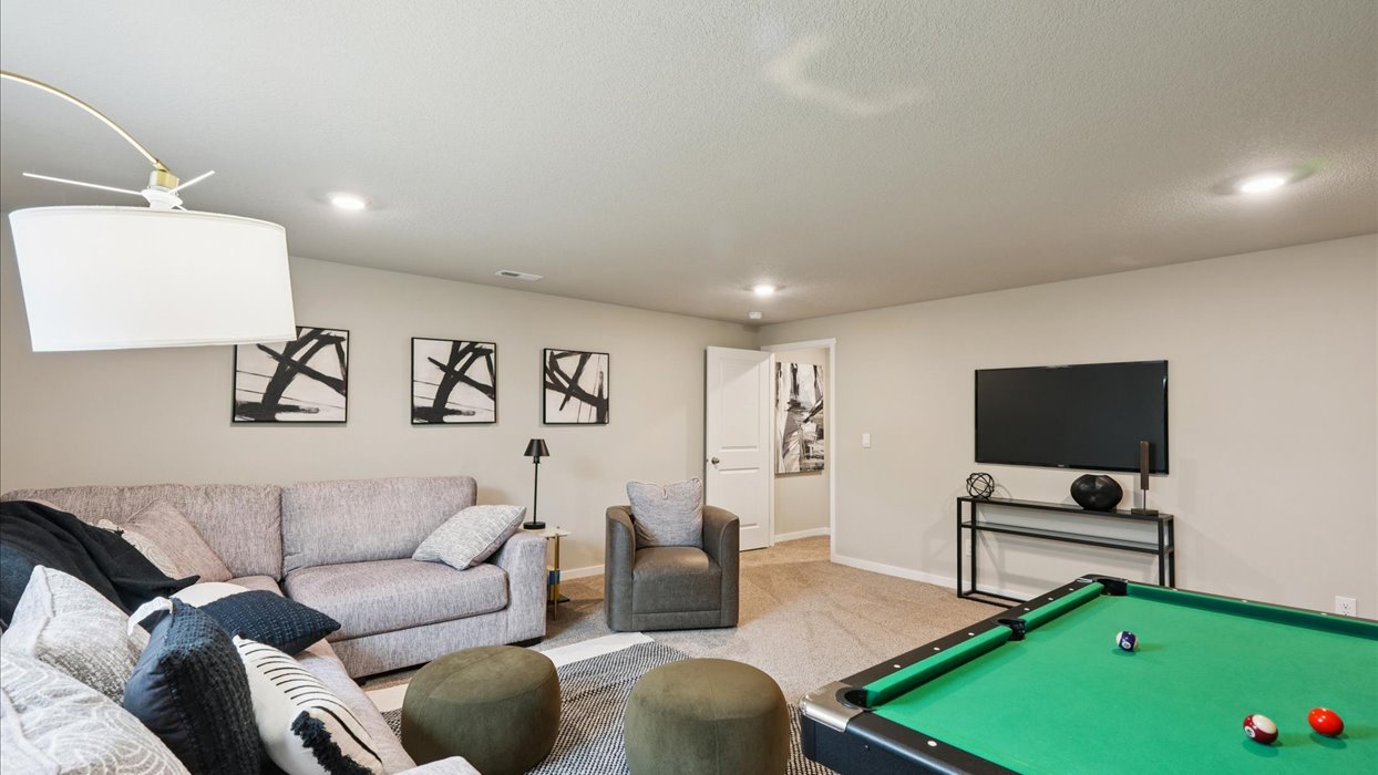 Finished basement living area with comfortable seating space and flexible room for entertaining or relaxing.