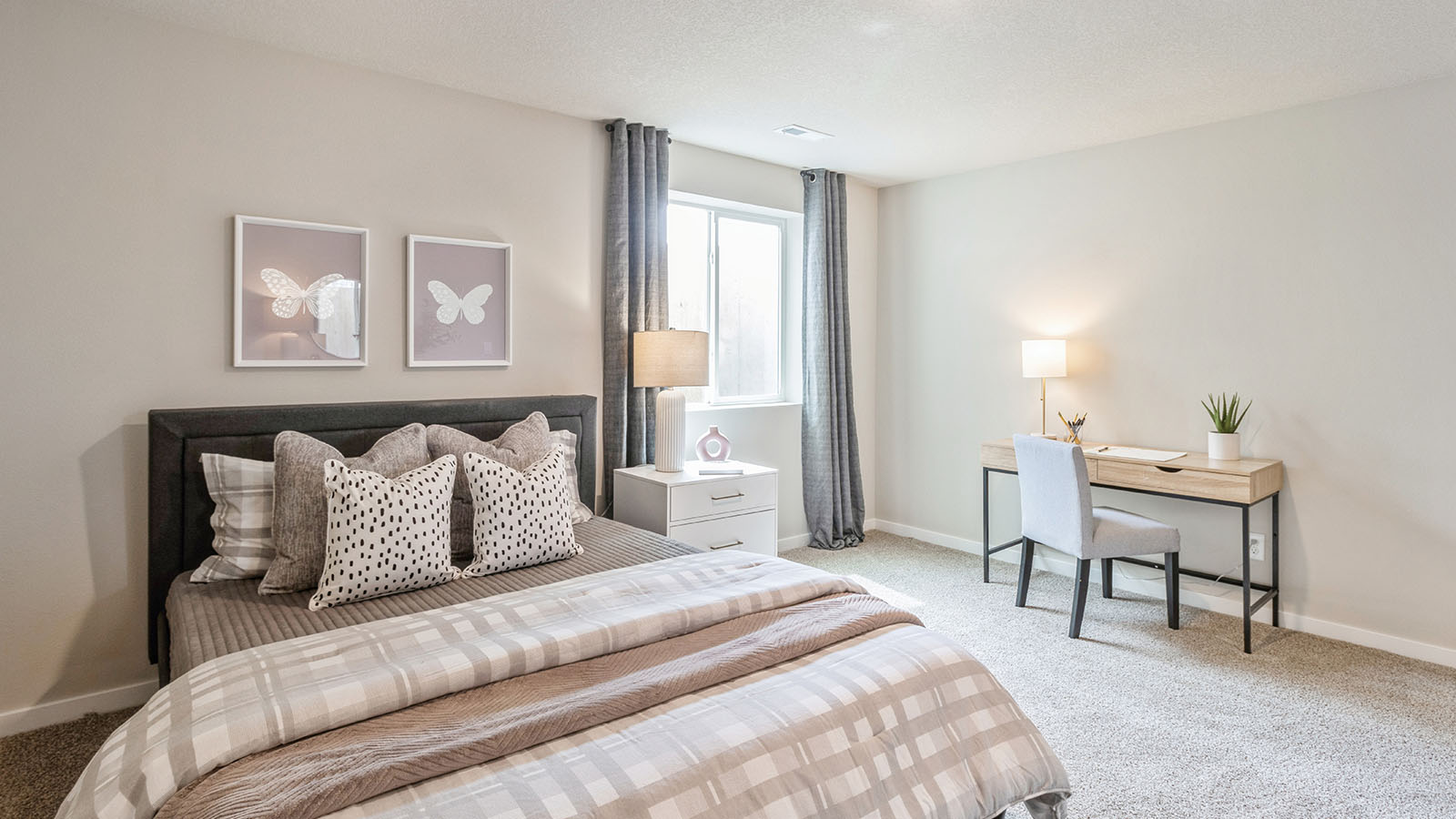 Private lower-level bedroom with natural light and functional storage space.
