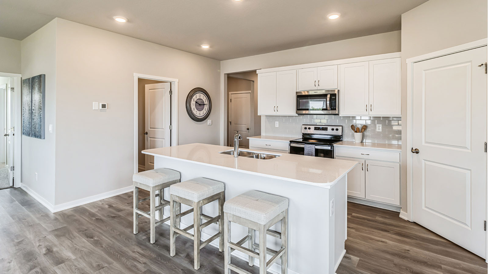 Kitchen with white cabinetry and quartz countertop
