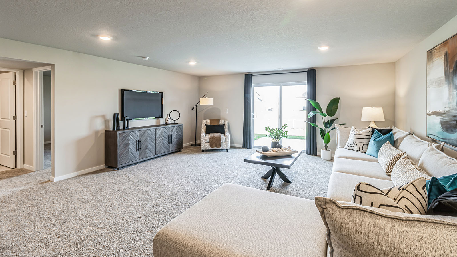 Finished basement living area with comfortable seating space and flexible room for entertaining or relaxing.