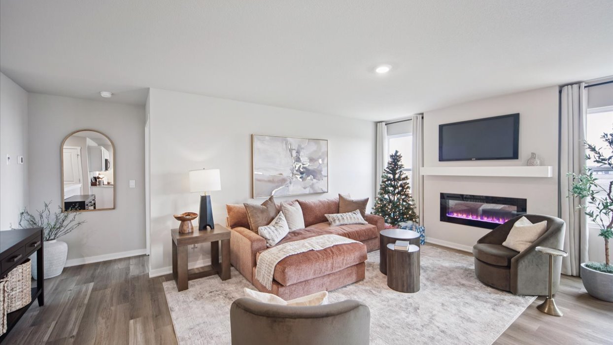 living room with pink couch and electric fireplace