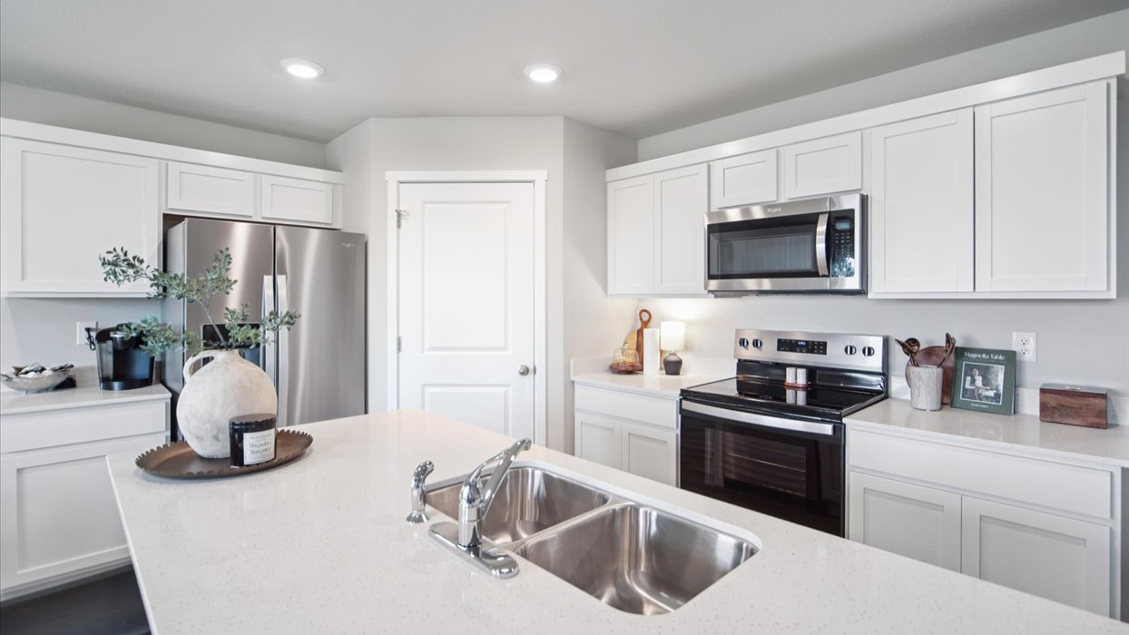 kitchen with white cabinets and quartz countertops