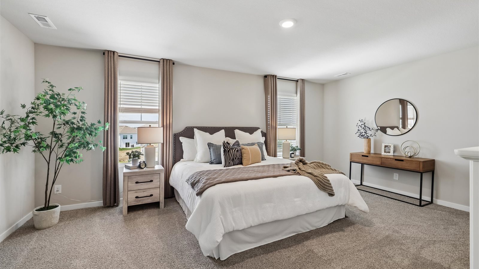 Spacious primary suite with natural light, attached bathroom, & walk in closet