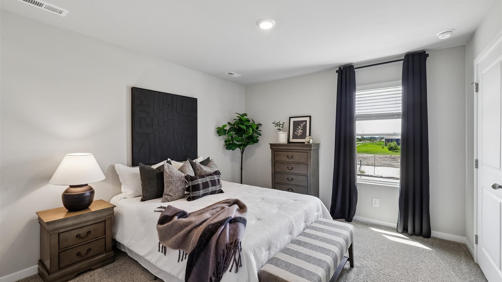 Comfortable secondary bedroom with natural light, modern finishes, and versatile living space.