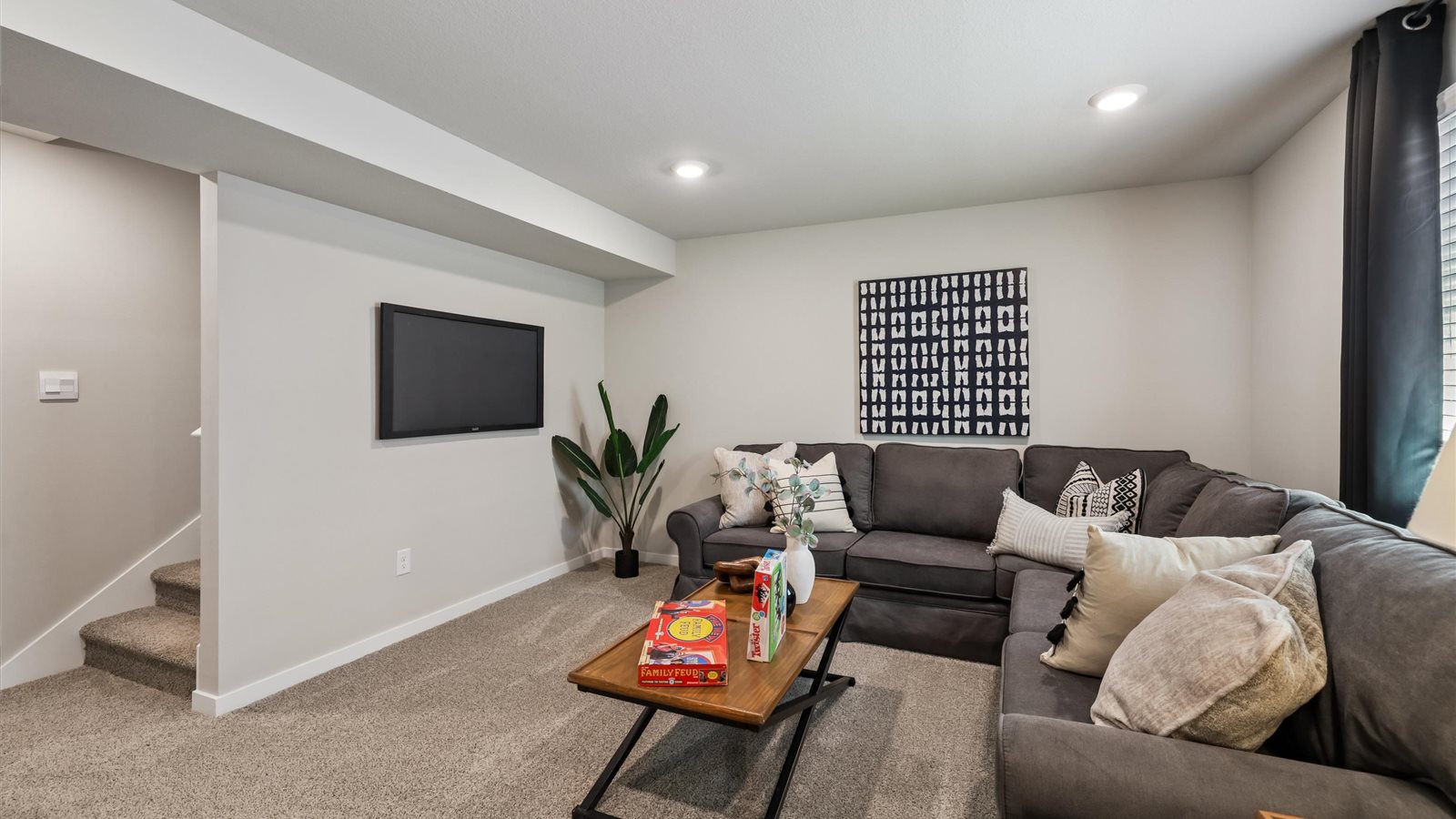 Finished basement living area with comfortable seating space and flexible room for entertaining or relaxing.