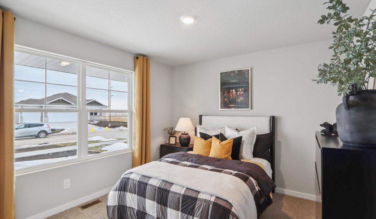 Comfortable secondary bedroom with natural light, modern finishes, and versatile living space.