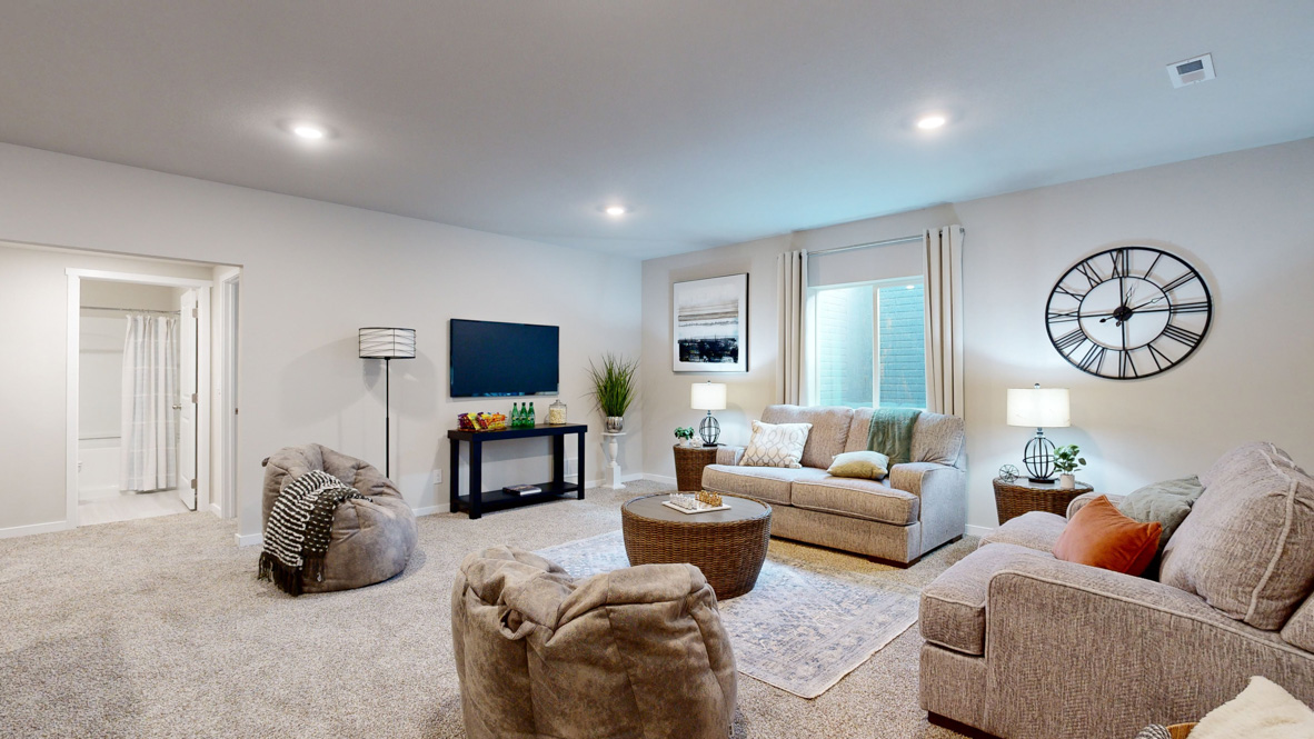 Finished basement living area with comfortable seating space and flexible room for entertaining or relaxing.
