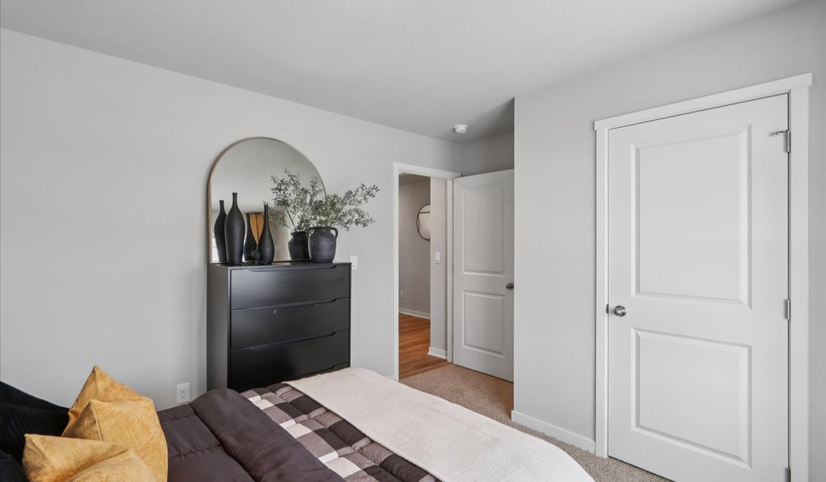 Comfortable secondary bedroom with natural light, modern finishes, and versatile living space.