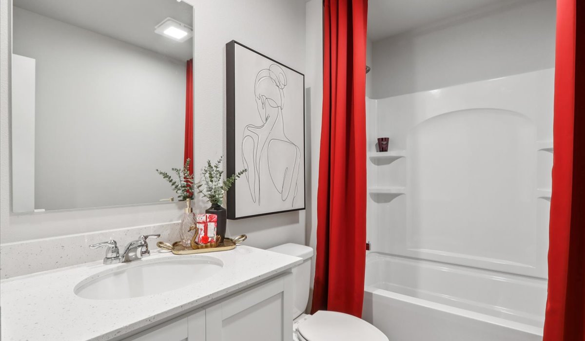 Stylish full bathroom with bright lighting and functional design.