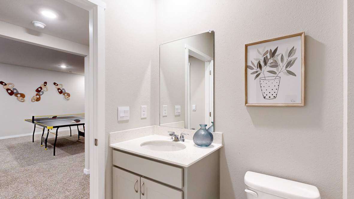 Stylish lower-level bathroom featuring contemporary fixtures and convenient access from the finished basement.
