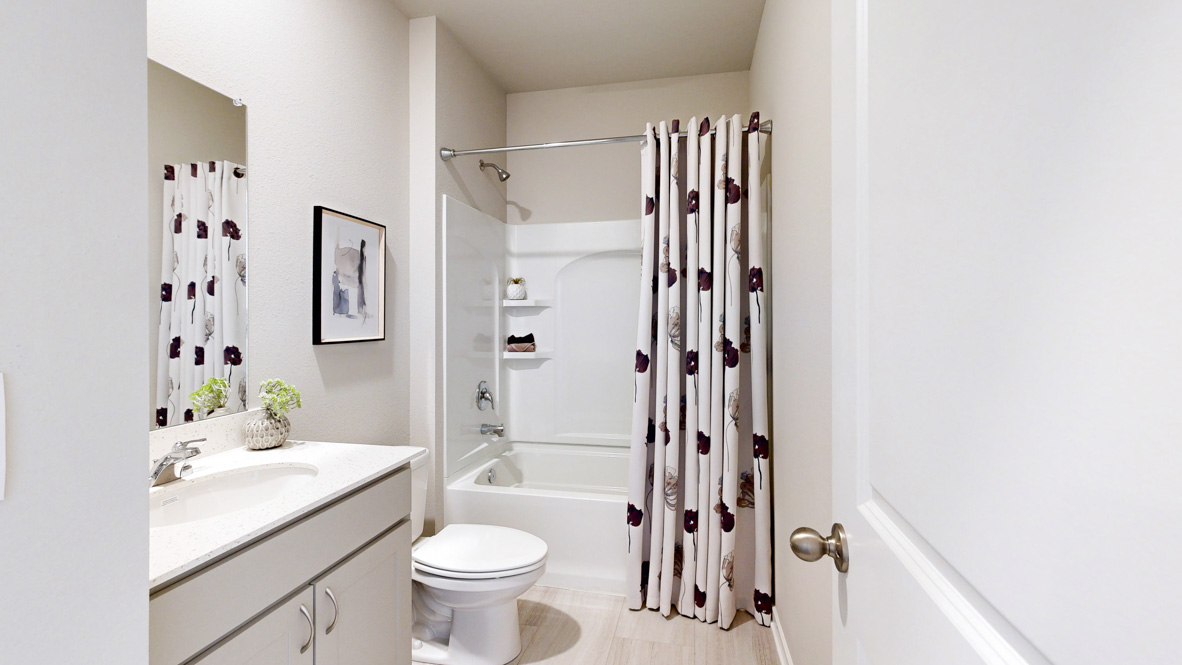Stylish lower-level bathroom featuring contemporary fixtures and convenient access from the finished basement.
