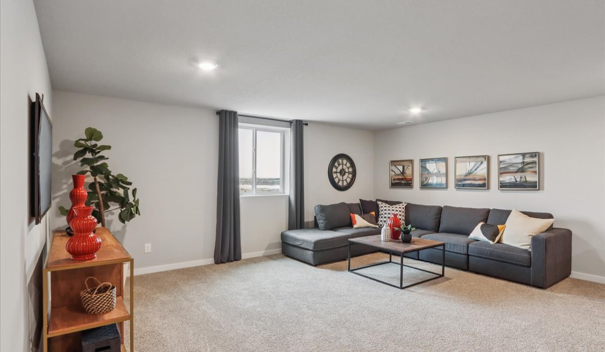Finished basement living area with comfortable seating space and flexible room for entertaining or relaxing.