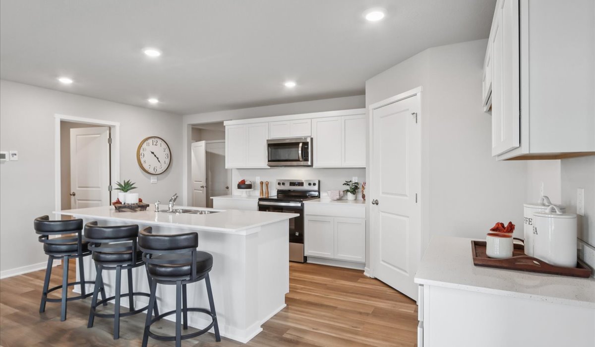 Kitchen with white cabinetry and quartz countertop