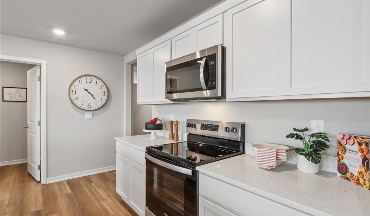Kitchen with white cabinetry and quartz countertop