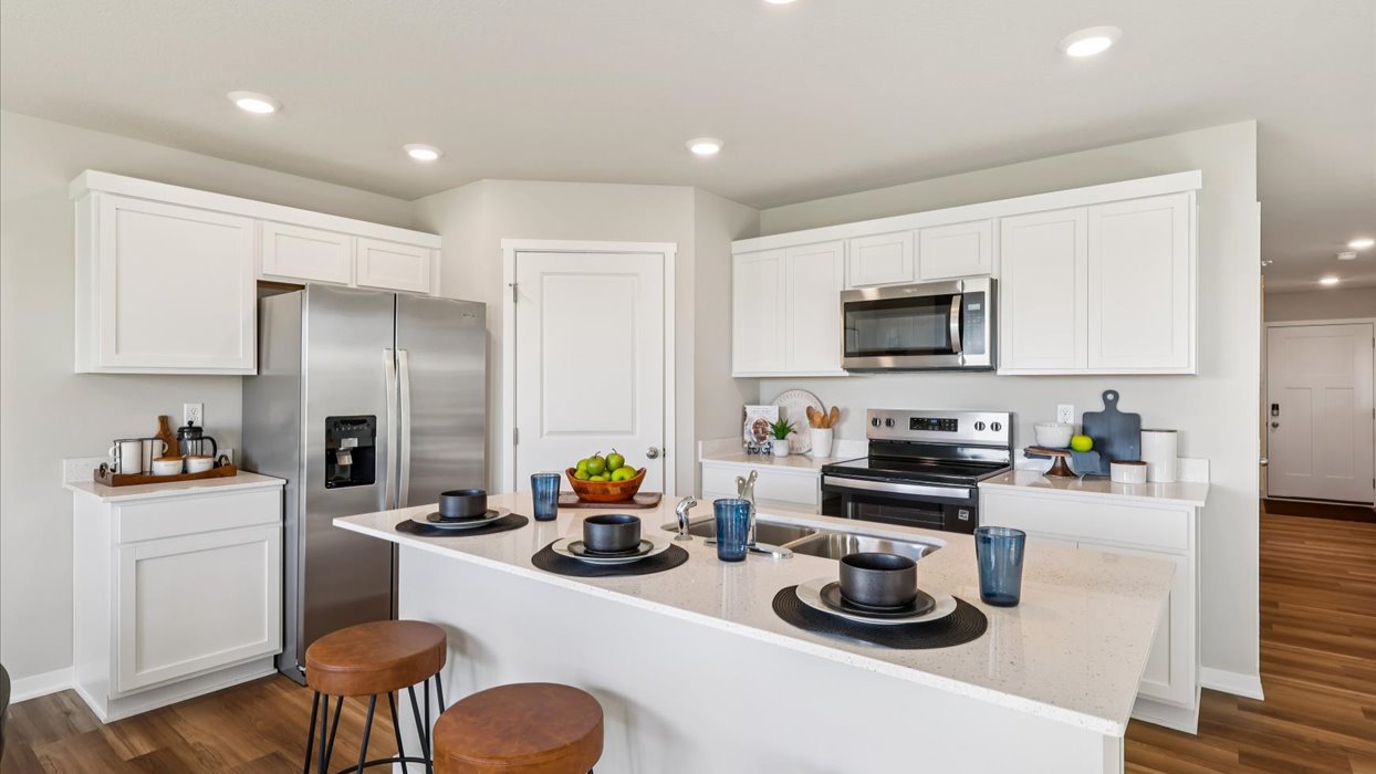 modern kitchen with white cabinets and quartz countertops