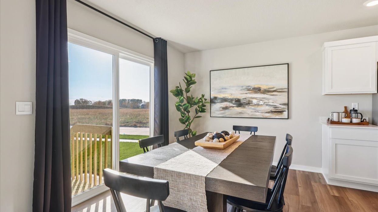 dining area with brown table and chairs next to sliding glass doors