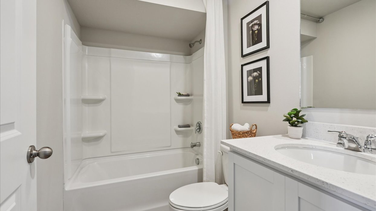 Bathroom with tub and shower combo, quartz countertops, and white vanity