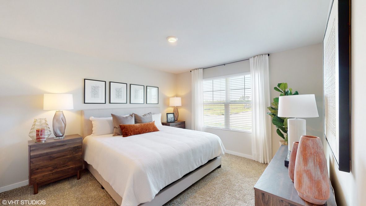Primary bedroom with king size bed and window